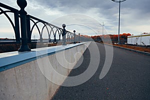 Black iron parapet along the paved path