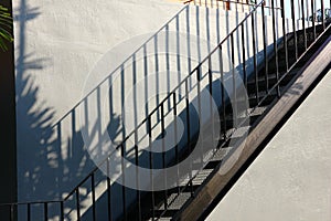 Black iron stairs on cement wall