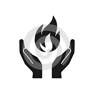 Black isolated icon of flame in hands on white background. Silhouette of fire and hands. Symbol of healing. Flat design