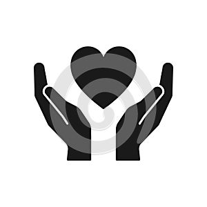 Black isolated icon of heart in hands on white background. Silhouette of heart and hands. Symbol of care, love, charity