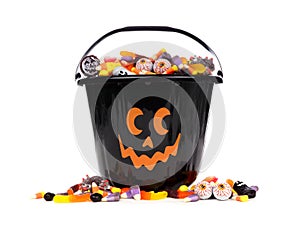 Black Jack o Lantern candy collector with candy pile over white