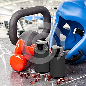 Black jar with sports nutrition red capsules with kettlebells and dumbbells.