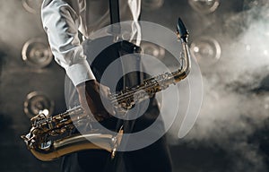 Black jazz musician with saxophone on the stage
