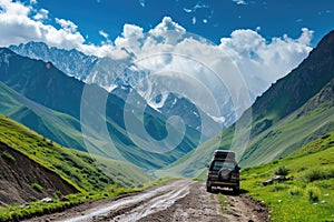 A black jeep with a cargo box is seen driving down a rugged dirt road surrounded by majestic mountains and lush greenery