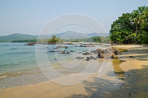 Black Johnson Beach in Sierra Leone, Africa with calm sea, ropcks, and deserted beach