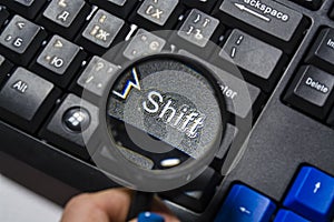 The black keyboard from the computer with a magnifying glass. Keys enter and shift. Tool. Press. Typing.