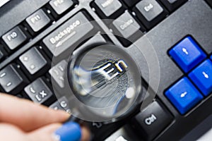 The black keyboard from the computer with a magnifying glass. Keys enter and shift. Tool. Press. Typing.