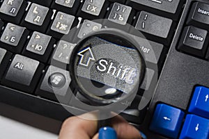 The black keyboard from the computer with a magnifying glass. Keys enter and shift. Tool. Press. Typing.