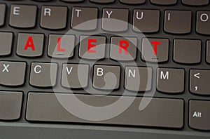 On the black keyboard, the inscription is highlighted in red - Alert