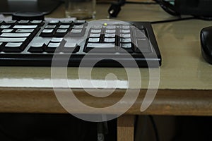 Black keyboard in work desk