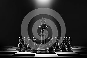Black king chess standing in front of the pawn chess