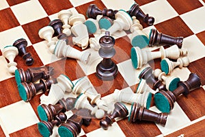 Black king and scattered chess pieces