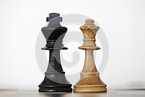 Black king and white queen wooden chess pieces