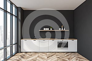 Black kitchen interior with white countertops