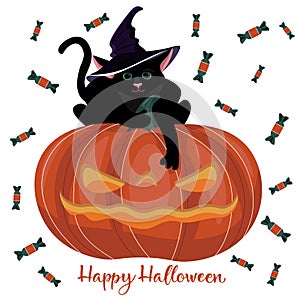 A black kitten in a witch`s hat, who is sitting on a Halloween pumpkin in the form of a lantern with his paw hanging down.