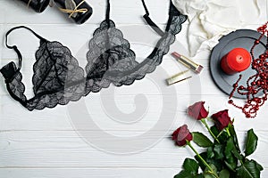 Black lace elegant lingerie composition with red roses and candle