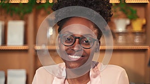 Black lady coffee seller woman with spectacles in shop Spbas