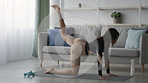 Black Lady Doing Quadruped Leg Raise Exercise Training At Home