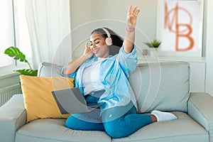 Black Lady Listening Music Wearing Headphones Using Laptop At Home