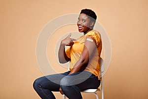 Black Lady Showing Arm After Getting Vaccine Injection, Beige Background