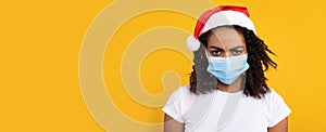 Black Lady Wearing Mask And Christmas Santa Hat, Studio Shot