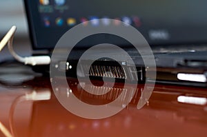 Black laptop side view with connected wire