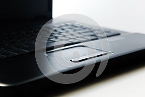 Black laptop touchpad on white background