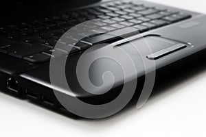 Black laptop touchpad on white background