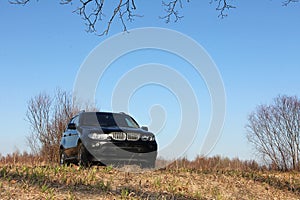 Black large car on the background of green nature