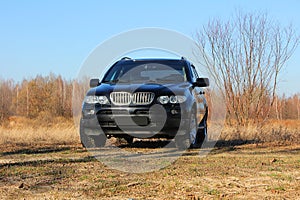 Black large car on the background of green nature