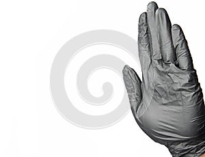 Black latex glove stop hand sign on isolation white background simple pattern wallpaper advertising health care medical concept