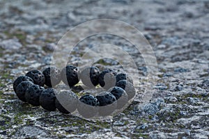 Black lava bracelet on a stone parapet
