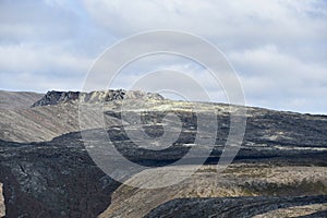 Black lava flow on the mountains of a volcano in Iceland North of Europe