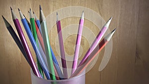 Black lead pencils with bright coloring of wooden part turn in a glass