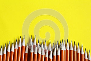 Black lead pencils on a yellow background