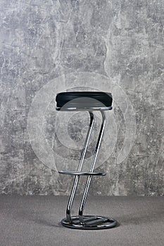 Black Leather bar chair in empty room with gray texture wall background