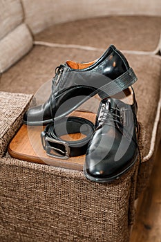 Black leather belt and black leather men's shoes. Groom accessories