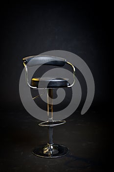 Black leather and chrome barbershop chair. photo