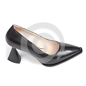 Black leather fashionable shoes with triangular heels on a white background