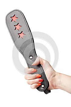 Black leather fetish paddle in female hand isolated on white