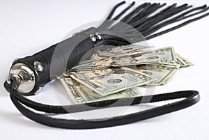 Black Leather Flogging Whip and money. photo