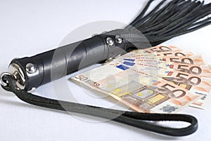 Black Leather Flogging Whip and money. photo