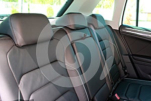 Black Leather interior design, car passenger clean, angle view side. Back passenger seats in modern comfortable car.