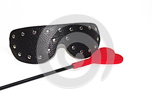 Black leather mask with metal rivets and red crop isolated on white