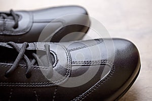 Black leather men shoes on wooden background