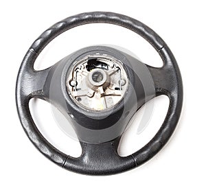 Black leather shiny steering wheel with a metal frame a separate part of the car on a white isolated background in the workshop