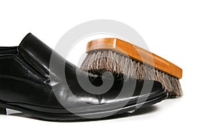 Black leather shoe and brush