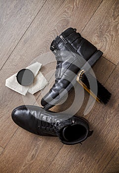 Black leather shoes on a wooden floor