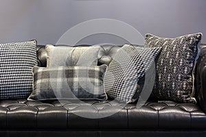 black leather sofa and pillows