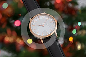 Black leather strap wrist watch in Christmas time